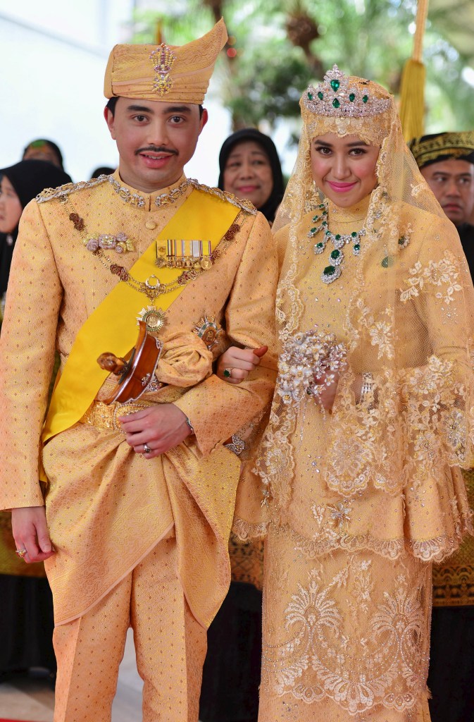 Brunei's newly wed royal couple, Prince Abdul Malik and Dayangku Raabi'atul 'Adawiyyah Pengiran Haji Bolkiah, pose for photographers after their enthronement ceremony.