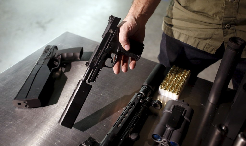 SilencerCo CEO Joshua Waldron shows off guns with suppressors in West Valley City, Utah, on Feb. 23, 2016.