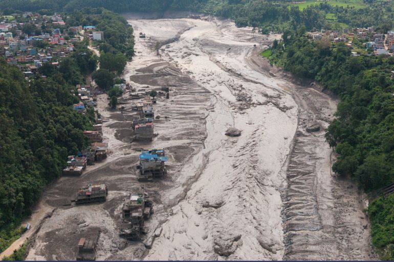 A drone view shows mud covering properties following a flash flood at Trishuli in Nuwakot district, Nepal, on August 26, 2026