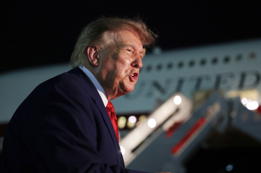 President Donald Trump speaks to reporters after stepping off Air Force One.