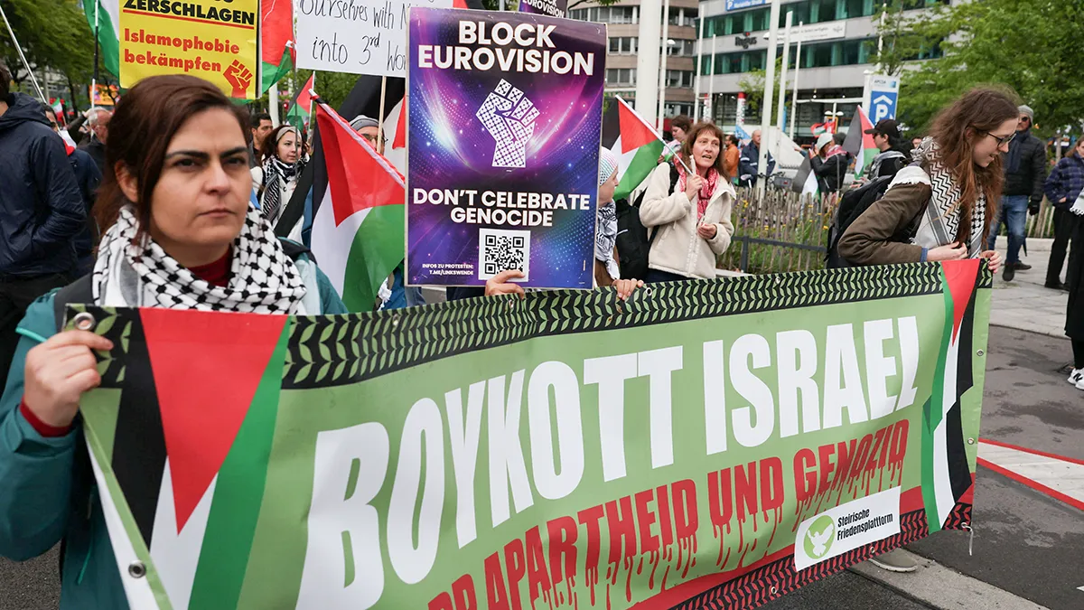 People hold a banner during a demonstration against Israel's participation in the Eurovision Song Contest, in Vienna, Austria, 16 May 2026 - REUTERS/ LEONHARD FOEGER