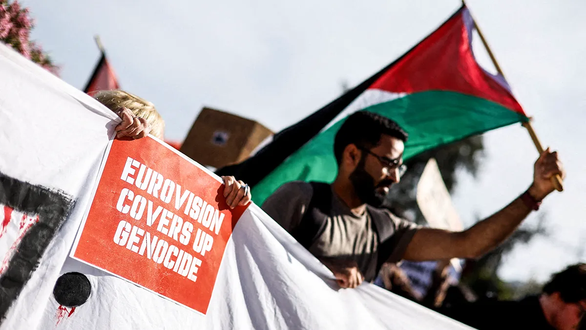 A pro-Palestinian protester holds a placard against the Eurovision Song Contest due to Israel's participation, during a solidarity rally marking the 78th anniversary of the Nakba, in Sliema, Malta, 16 May 2026 - REUTERS/ DARRIN ZAMMIT