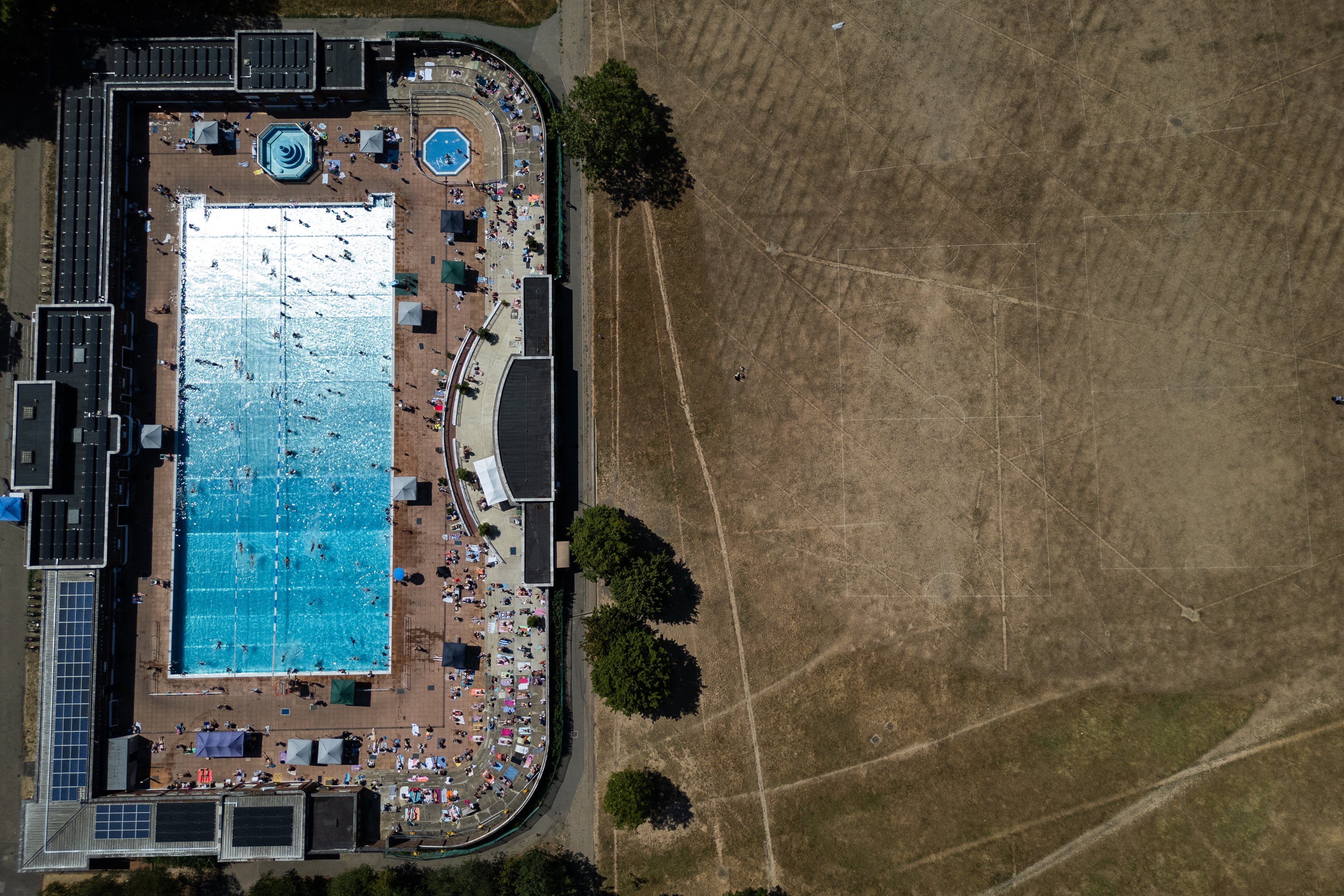 An aerial view shows swimmers using Parliament Hill Fields Lido in London
