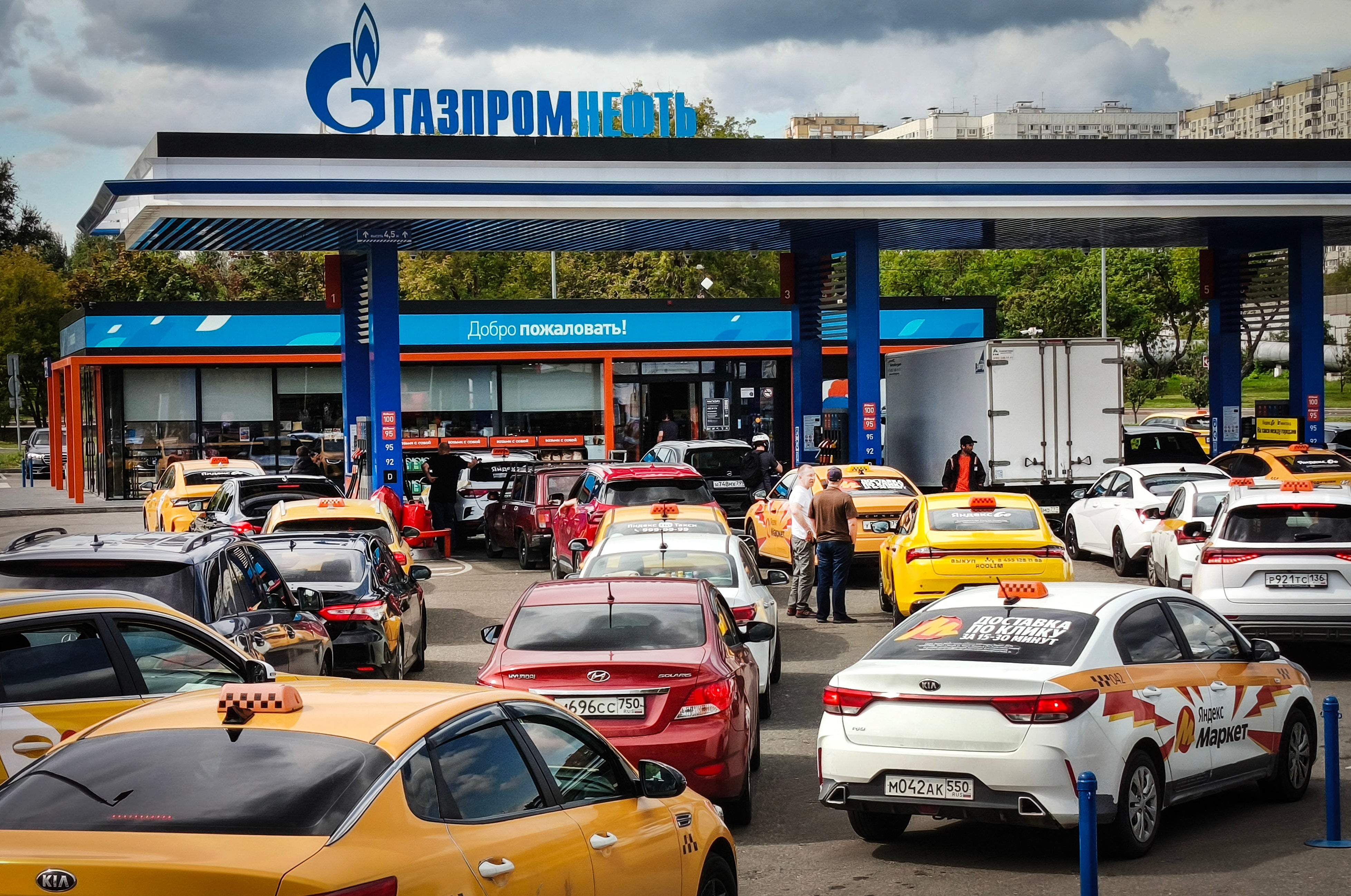 Vehicles queue at a a Gazpromneft petrol station in Moscow