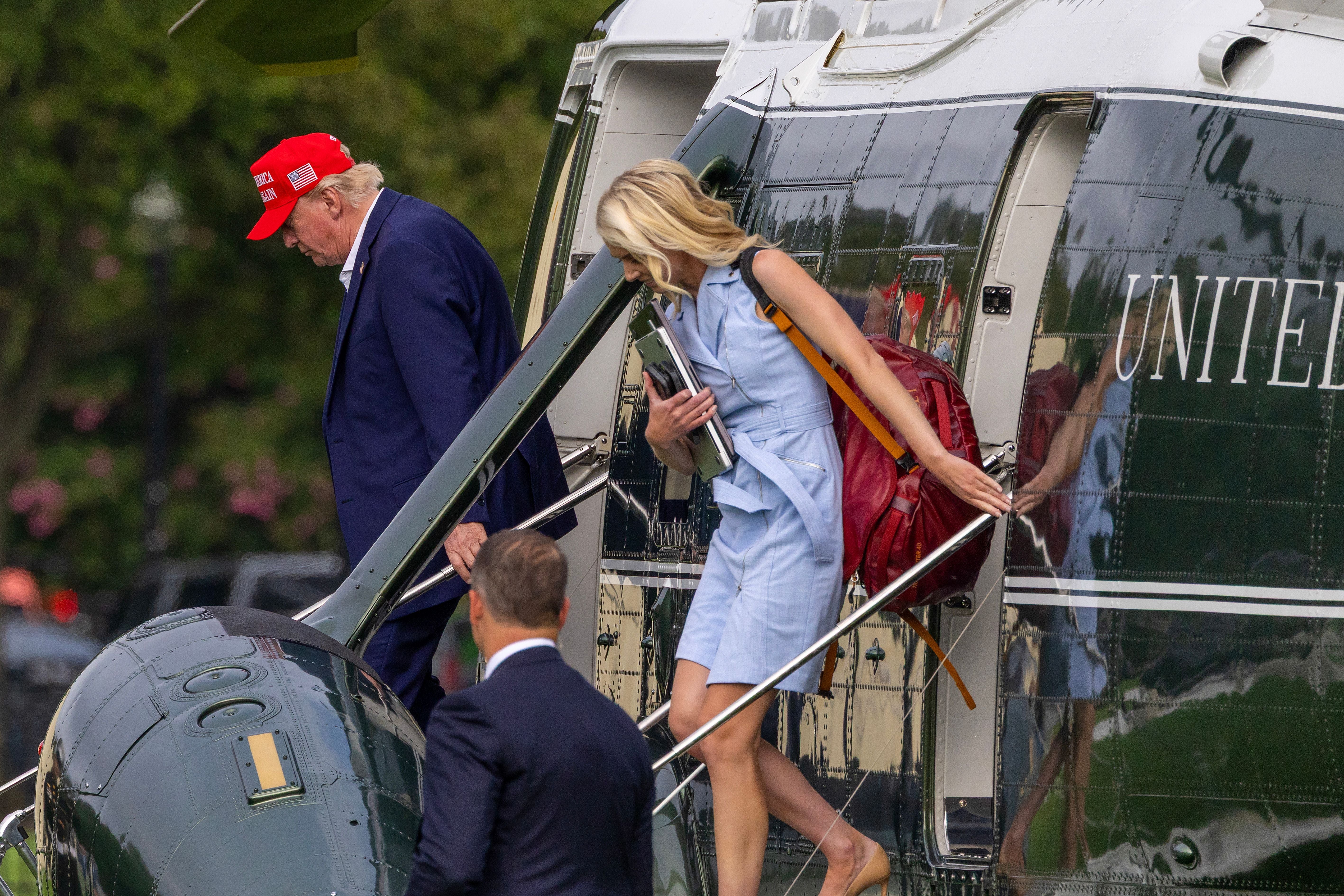 Trump's executive assistant, Natalie Harp, is seen disembarking from Marine One after landing in Washington on Sunday
