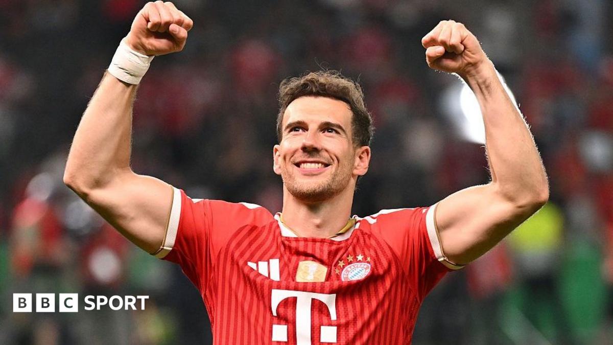 Leon Goretzka celebrates Bayern Munich's win the DFB Pokal final by raising both arms above his head