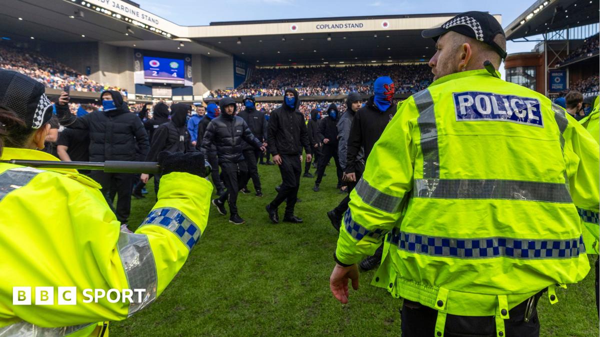 Rangers supporters confront police officers after last season's Scottish Cup quarter-final defeat by Celtic