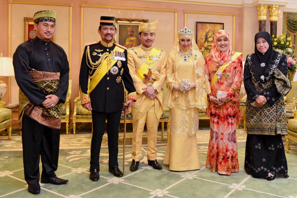 Brunei's newlywed royal couple and other members of the royal family pose for a photo during their wedding enthronement ceremony.