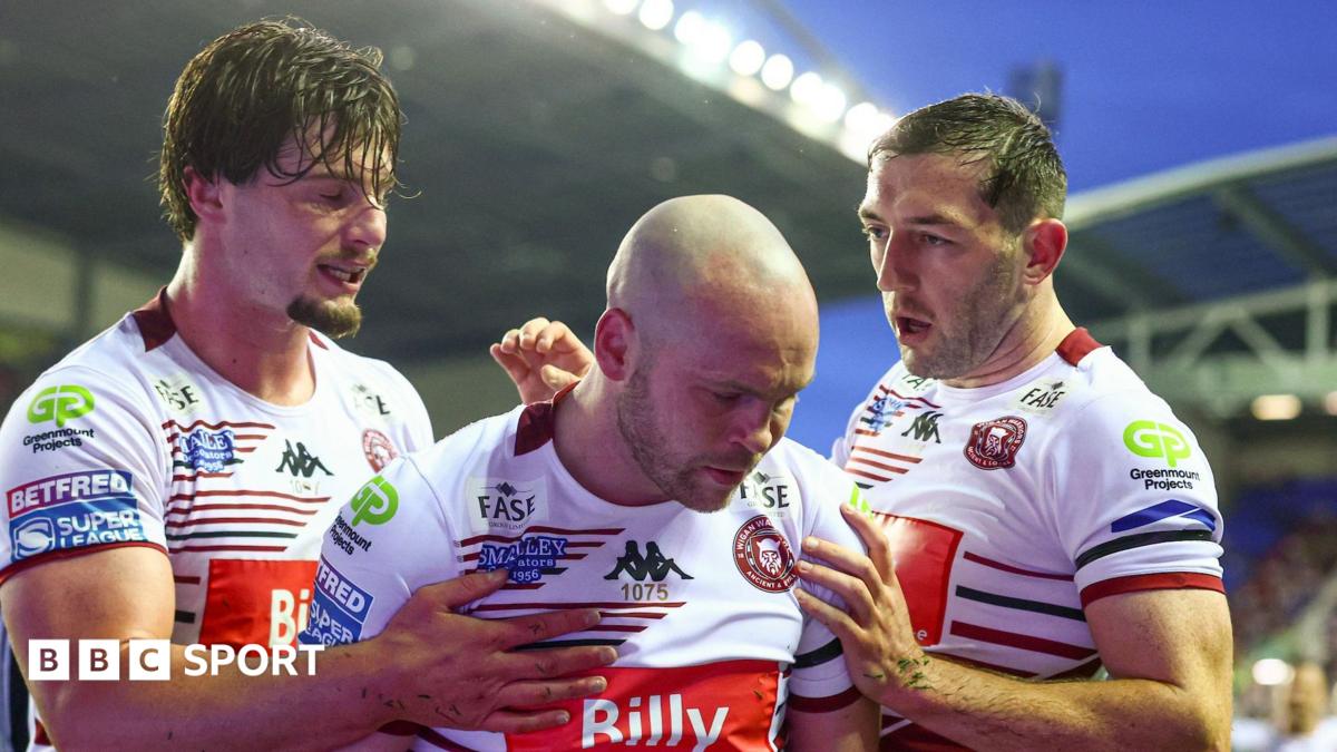 Liam Marshall (centre) celebrates scoring one of his tries for Wigan Warriors