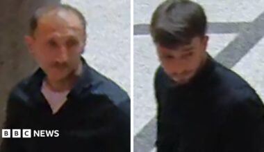 Grainy stills of two men walking through an atrium wearing dark tops.