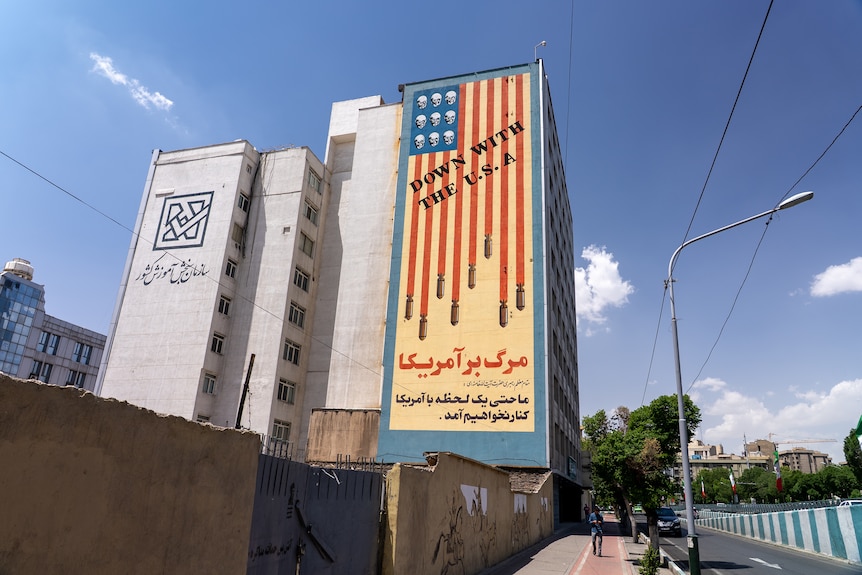 A large billboard on the side of a building that reads 'Down with the USA'.