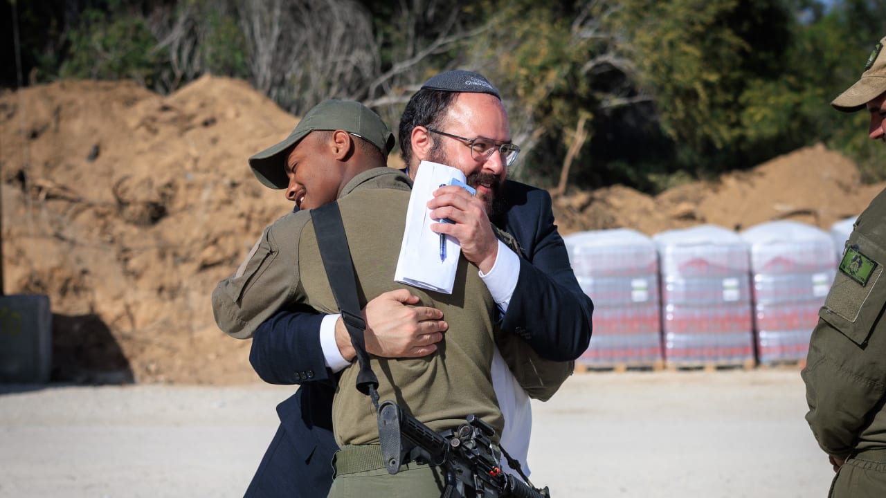 Rabbi Efraim Dochman of Colel Chabad embraces an IDF soldier during a visit to support troops serving on the front lines.