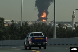 A smoke plume rise from an ongoing fire at Dubai International Airport in Dubai on March 16, 2026.