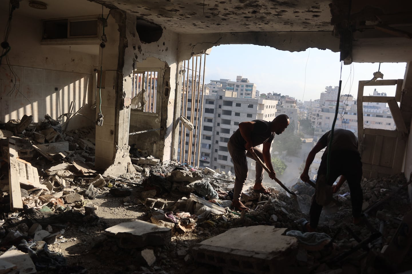 Palestinian residential salvage what they can from an apartment targeted in overnight Israeli airstrikes in Gaza City on Sunday.