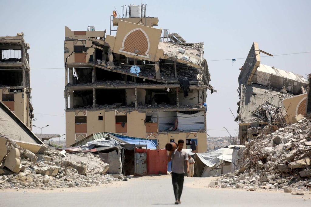 An internally displaced Palestinian man walks past the rubble of buildings destroyed by the Israeli military, in Khan Younis, southern Gaza Strip, on August 11, 2026. Photo: AFP
