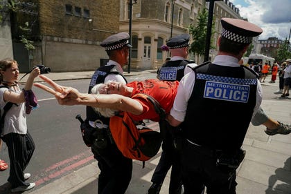 A demonstrator is arrested by the police outside the Westminster Magistrates Court in London, July, as a plea hearing for 25 people accused of showing support for Palestine Action takes place. Credit: Alberto Pezzali/AP A demonstrator is arrested by the police outside the Westminster Magistrates Court in London, July, as a plea hearing for 25 people accused of showing support for Palestine Action takes place.