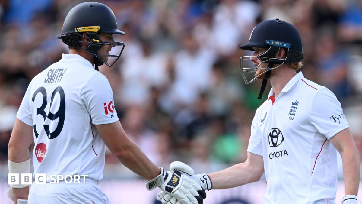 England Test captain Joe Root holding a bat and talking to Rob Key
