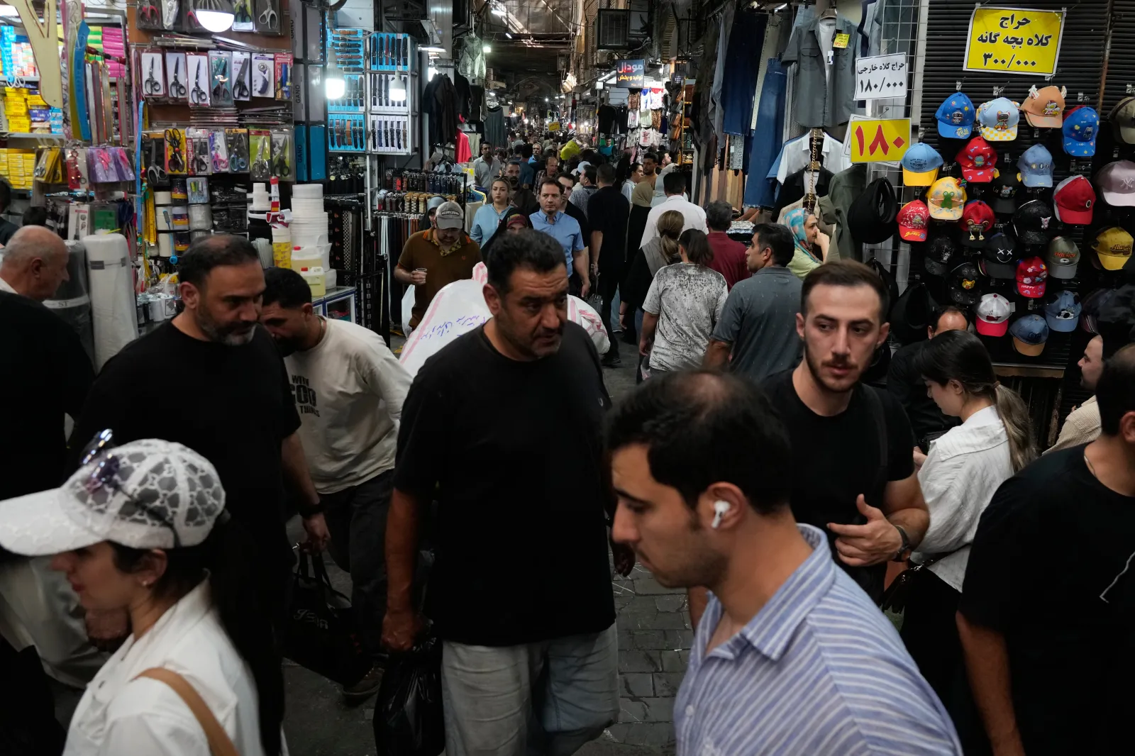 People walk in Tehran's traditional main bazaar on August 8, 2026.