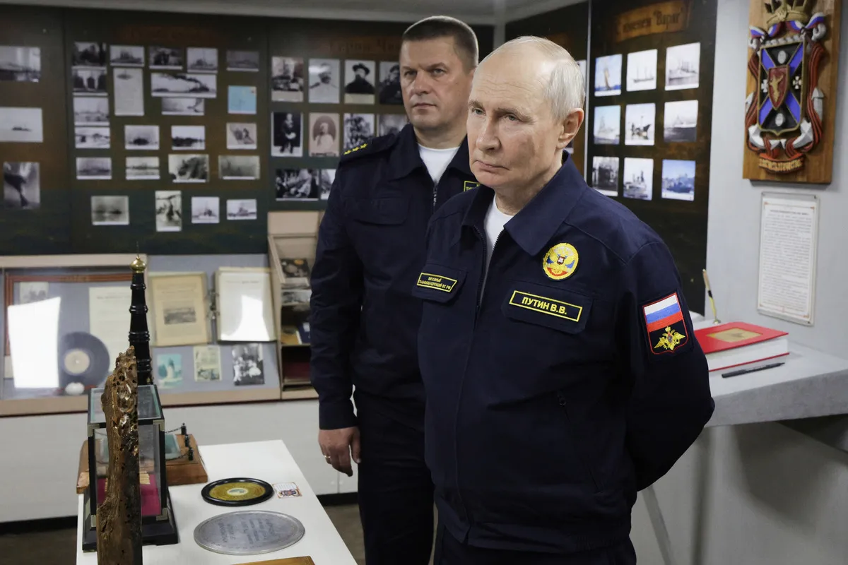 Russian President Vladimir Putin (R) and Admiral Viktor Liina visit the Varyag missile cruiser to watch a military exercise near Yuzhno-Sakhalinsk on August 12, 2026.