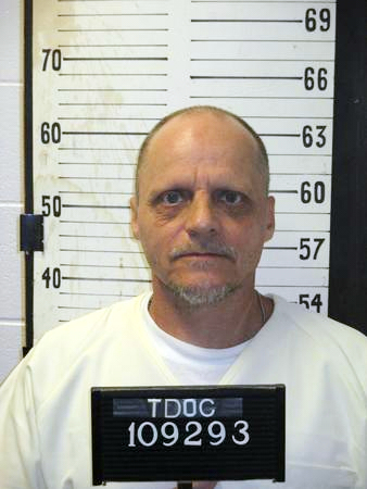Mugshot of a balding white man with a goatee in a white shirt, with a board around his neck reading "TDOC 109293".