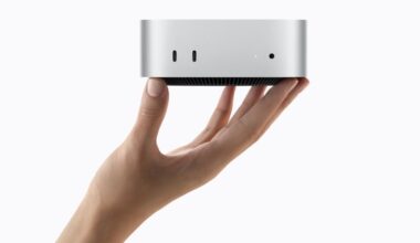 hand holding up Apple Mac Mini