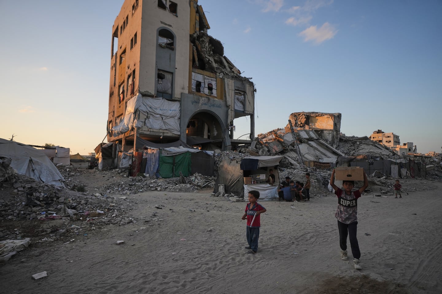 Children walked amid the ruins of buildings destroyed by Israeli airstrikes, on Monday.