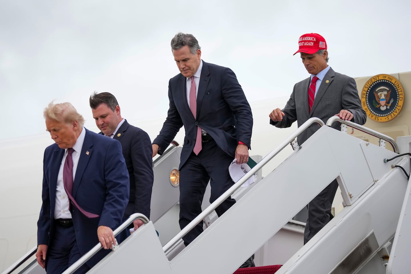 From left to right: President Trump, US Representative Ryan Mackenzie (R-PA), US Senator David McCormick (R-PA), and US Representative Dan Meuser (R-PA) exited from Air Force One after returning from Pennsylvania on June 23, at Joint Base Andrews.
