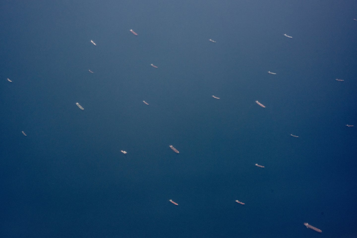 Ships near the Strait of Hormuz, as seen from a plane near the United Arab Emirates, July 20, 2026. Iran has survived decades of sanctions. Faced with more, it is likely to escalate rather than surrender, analysts said.