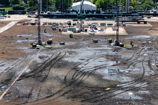 Workers pack up Lollapalooza stages and tents in muddy Hutchinson Field at the south end of Chicago's Grant Park on Aug. 3, 2026. (Brian Cassella/Chicago Tribune)