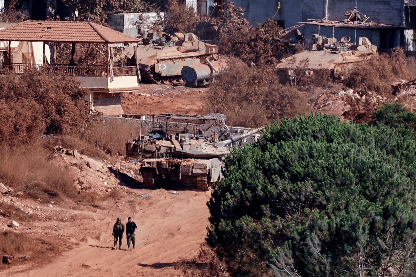 A photograph taken from the southern Lebanese viallage of of Zawtar al-Gharbiyah shows Israeli troops stationed in the nearby village of Zawtar al-Charkiyah on Aug. 11, 2026. Israeli twin strikes on southern Lebanon wounded two people on Aug. 11, and damaged an ambulance, the Lebanese health ministry said, condemning the "continued targeting" of rescuers. The incident is the latest Israeli strike despite an ongoing truce in the war between Israel and Iran-backed Hezbollah.
