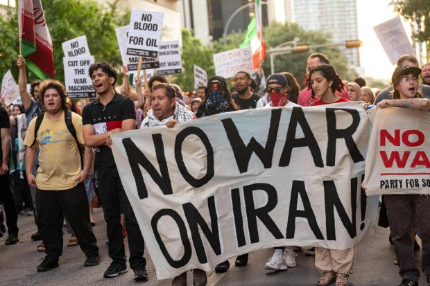 Protesters march in the streets of downtown Austin, Texas, in opposition to the Iran war.