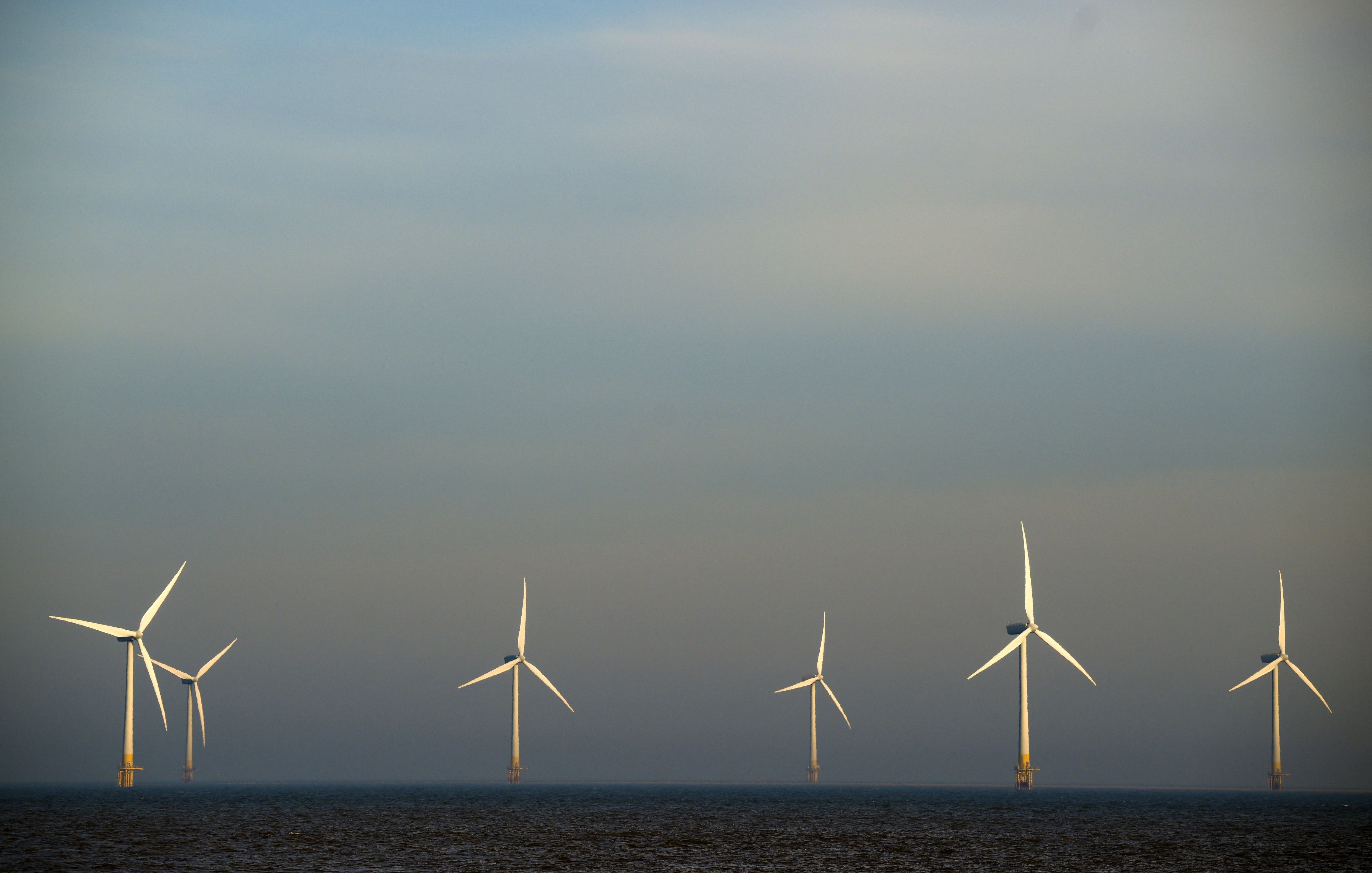 A firm run by one of Trump's wealthy Mar-a-Lago neighbors is set to reap millions as a result of a Trump administration settlement deal to scrap a wind farm project, according to a new report