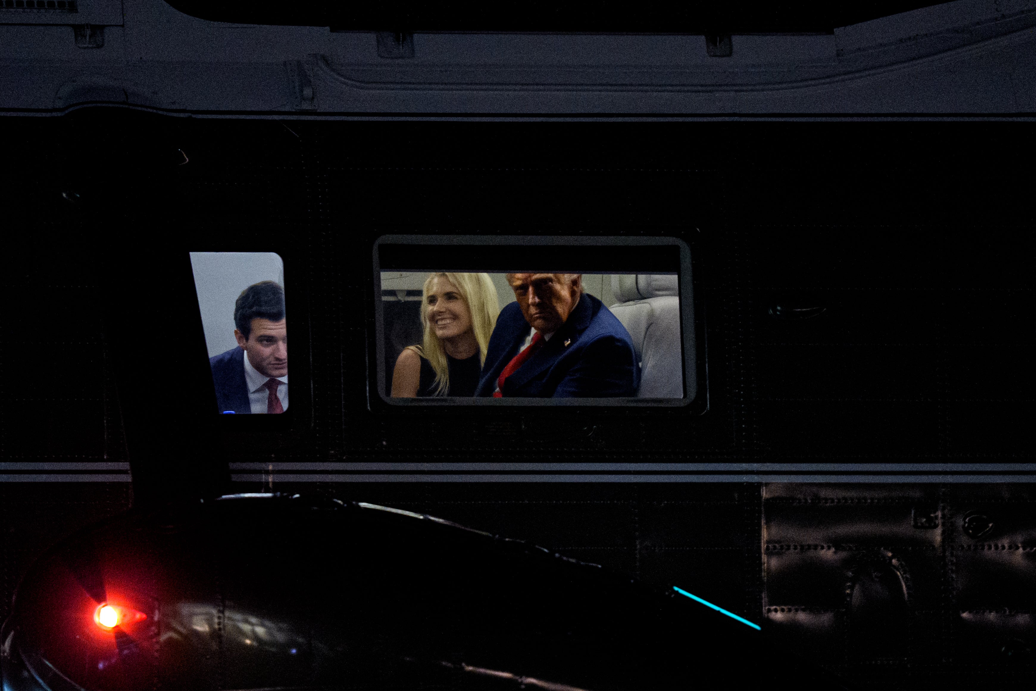 U.S. President Donald Trump (R), accompanied by Tiffany Trump's husband Michael Boulos (L), and aide Natalie Harp (C), looks out the window of Marine One as it lands on the South Lawn of the White House. U.S. Representative Debbie Dingell responded to Trump’s threat to rename Lake Ontario by suggesting if it were renamed to ‘Lake Natalie’ he might care about the Great Lakes