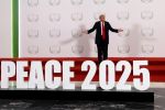 U.S. President Donald Trump gestures as he poses next to a sign at a world leaders' summit on ending the Gaza war, amid a U.S.-brokered prisoner-hostage swap and ceasefire deal between Israel and Hamas, in Sharm el-Sheikh, Egypt, October 13, 2025.