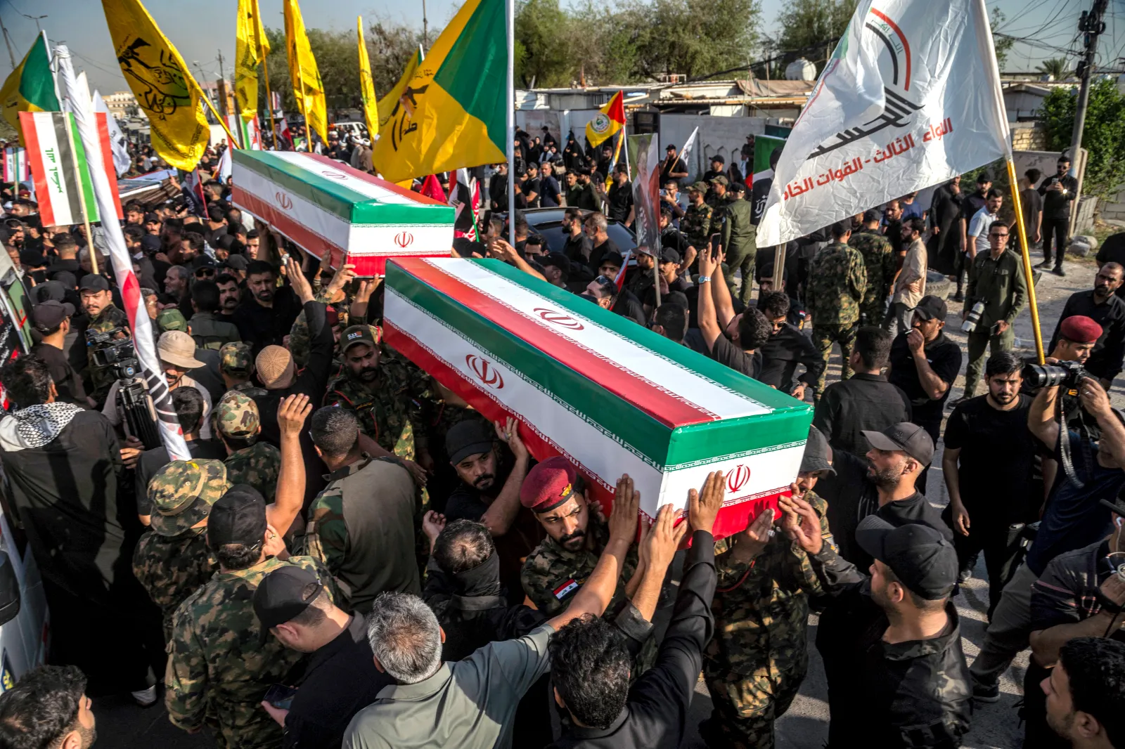 Mourners carry the bodies of members of Iraq's Popular Mobilization Forces who were killed earlier in Diyala in central Iraq by U.S.-Saudi strikes, during the funeral in Baghdad on July 29, 2026.