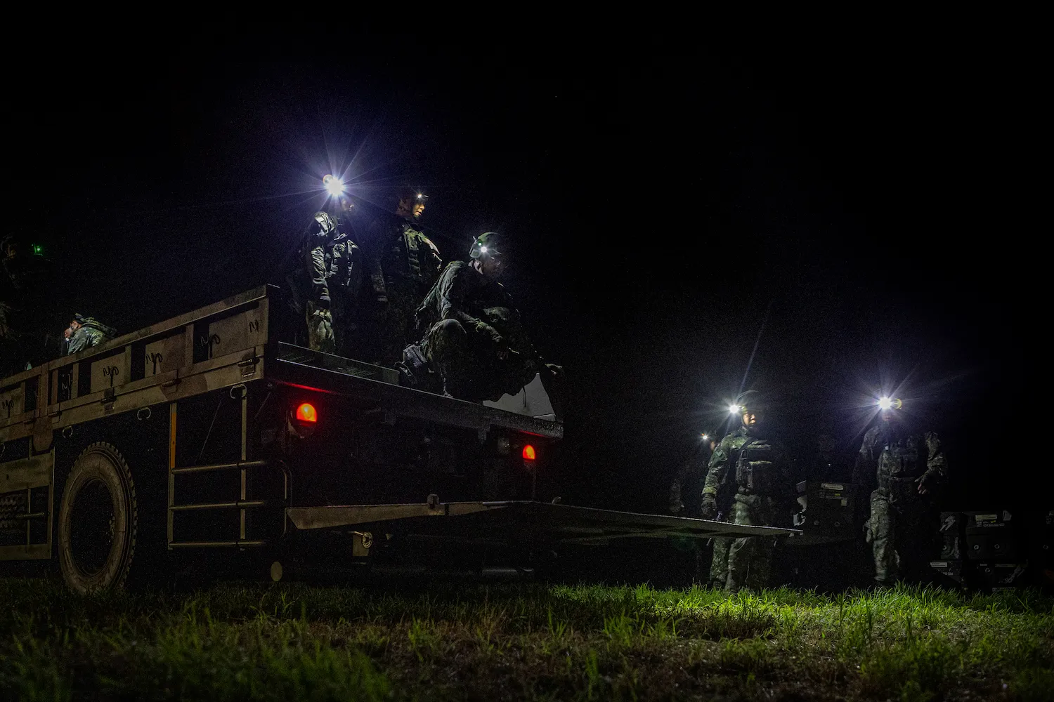 Soldiers load supplies onto a military truck with its lights off during a night tactical exercise in Tainan, Taiwan, on Aug. 12.