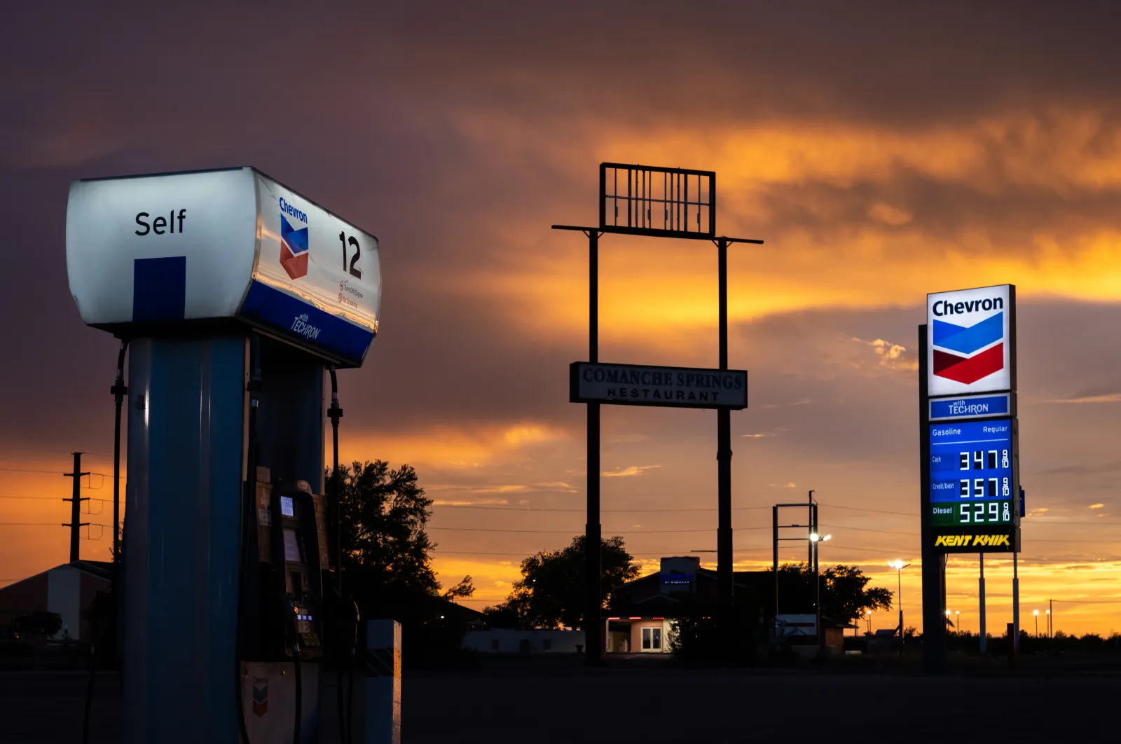 Gas and diesel prices are displayed at a Chevron gas station on August 14, 2026, in Fort Stockton, Texas.
