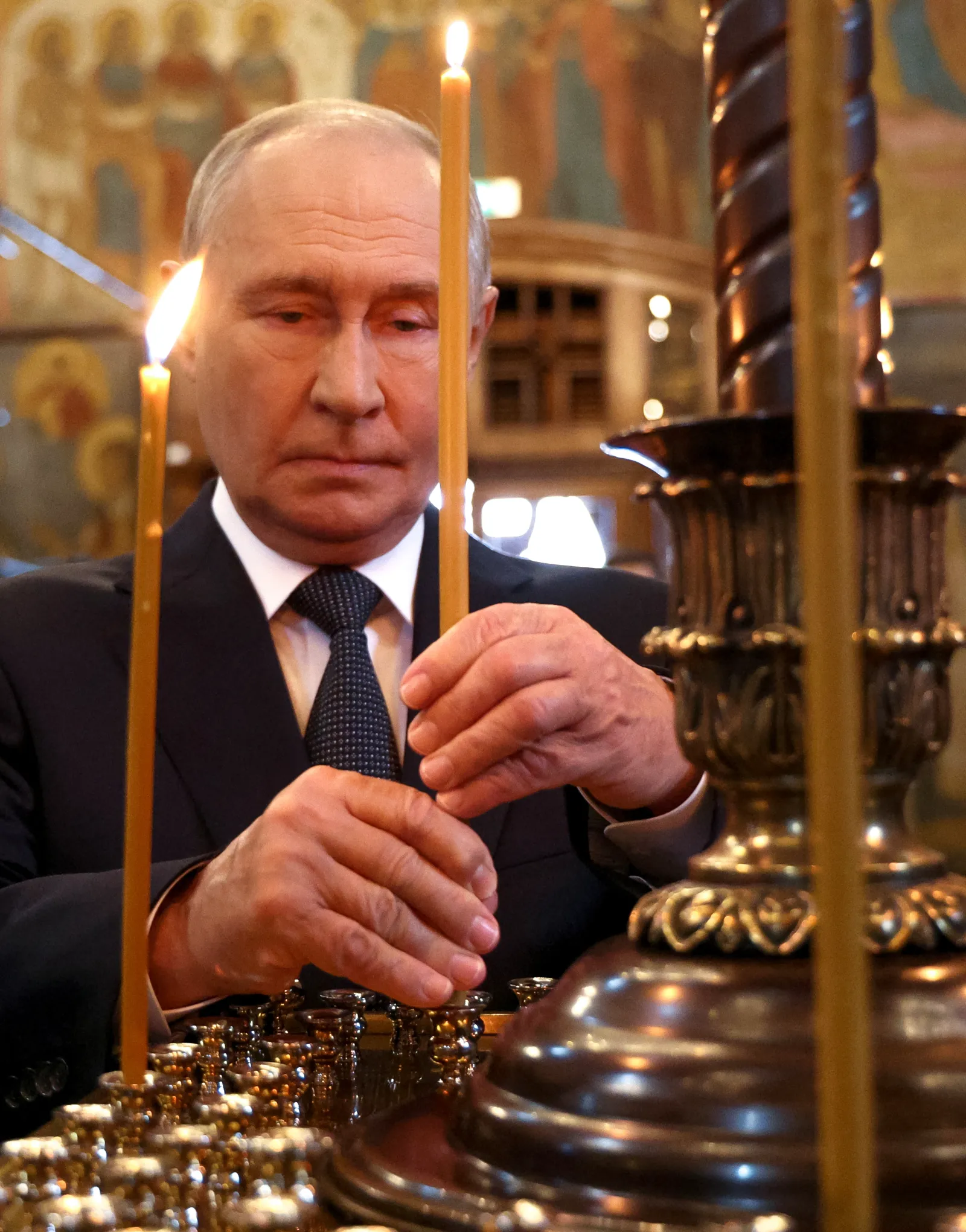 In this pool photograph distributed by the Russian state agency Sputnik, Russian President Vladimir Putin attends a prayer service in the Archangel Cathedral of the Kremlin in Moscow on August 20, 2026.