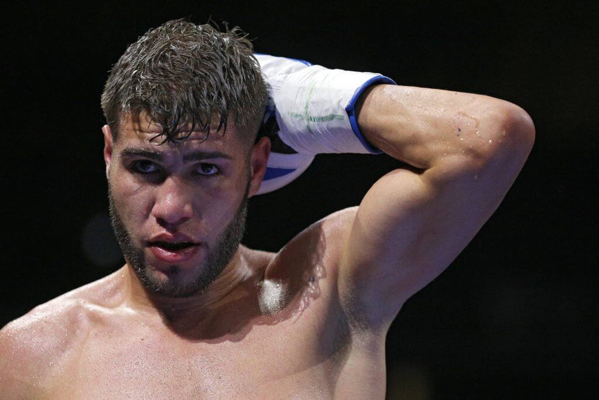 Prichard Colón holds the back of his head during a fight against Terrel Williams.