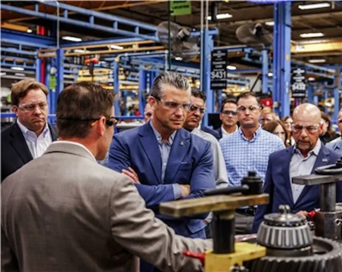 Secretary Hegseth and leadership from Oshkosh observe integrated assembly line during facility tour (Business Wire).
