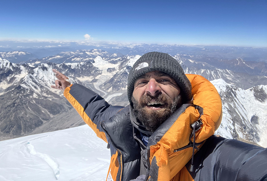 smiling climber pointing