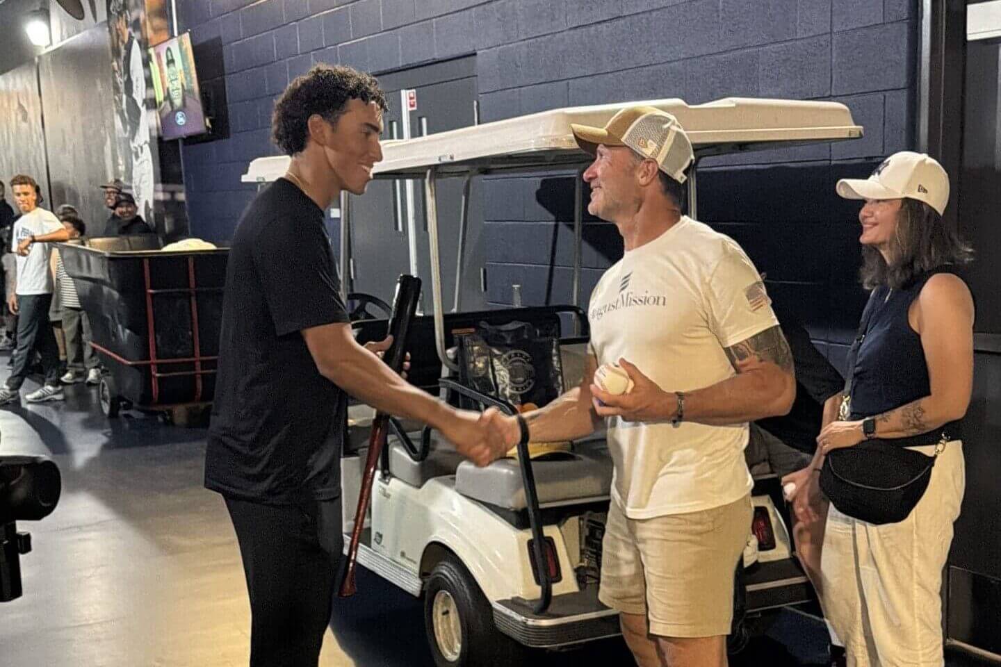 Bruce Roberts shakes hands with Yankees rookie George Lombard Jr..