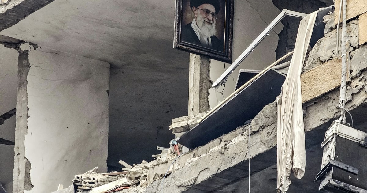 Iranian women look at a building, which was damaged in a U.S. and Israeli strike in March, in Tehran, Iran, August 22, 2026.