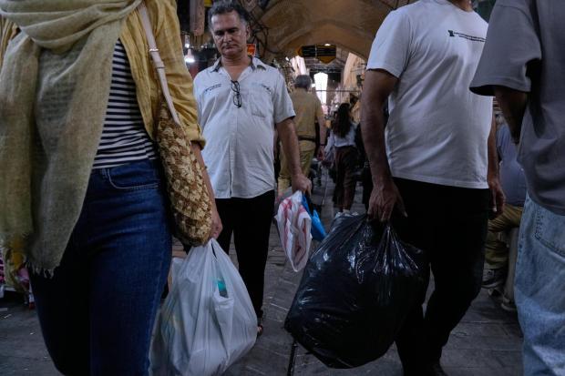 People shop at Tehran's traditional main bazaar.
