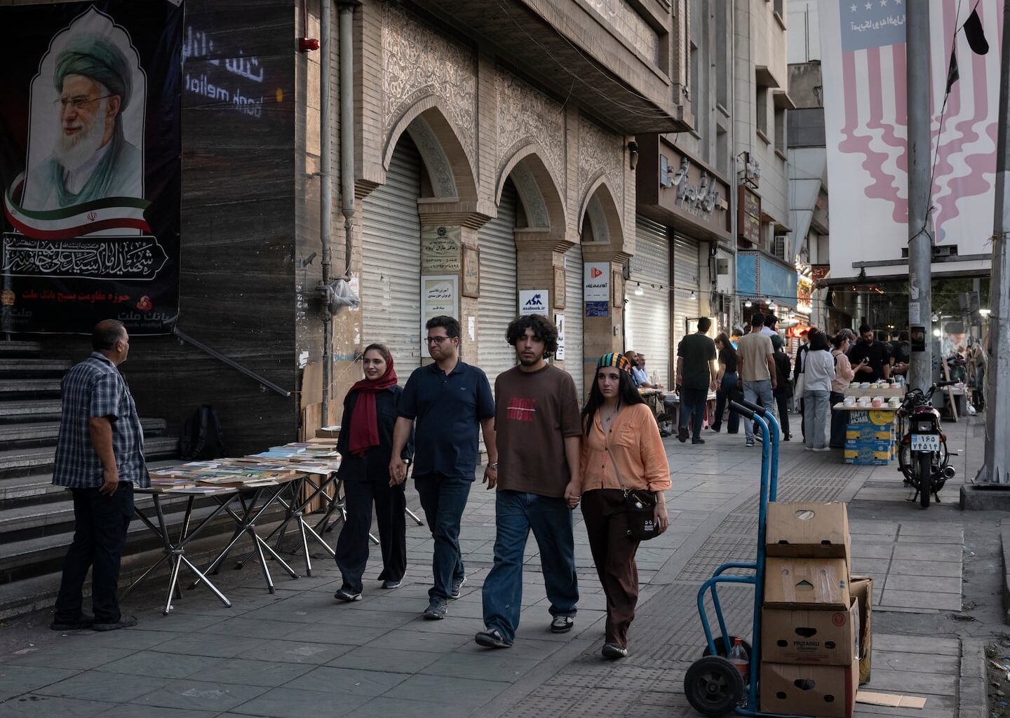 FILE — People walk along Enghelab street in the center of Iran's capital Tehran, July 7, 2026. President Trump’s replacement of a military war with a heightened economic one is not expected to alter Iran’s strategy, while further impoverishing its people.