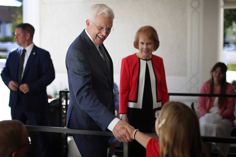 President D. Todd Christofferson, second counselor in the First Presidency of The Church of Jesus Christ of Latter-day Saints, greets Evaly Monroe while his wife, Sister Kathy Christofferson, waits to enter the temple during the rededication ceremony of the San Diego California Temple on Sunday, Aug. 23, 2026.