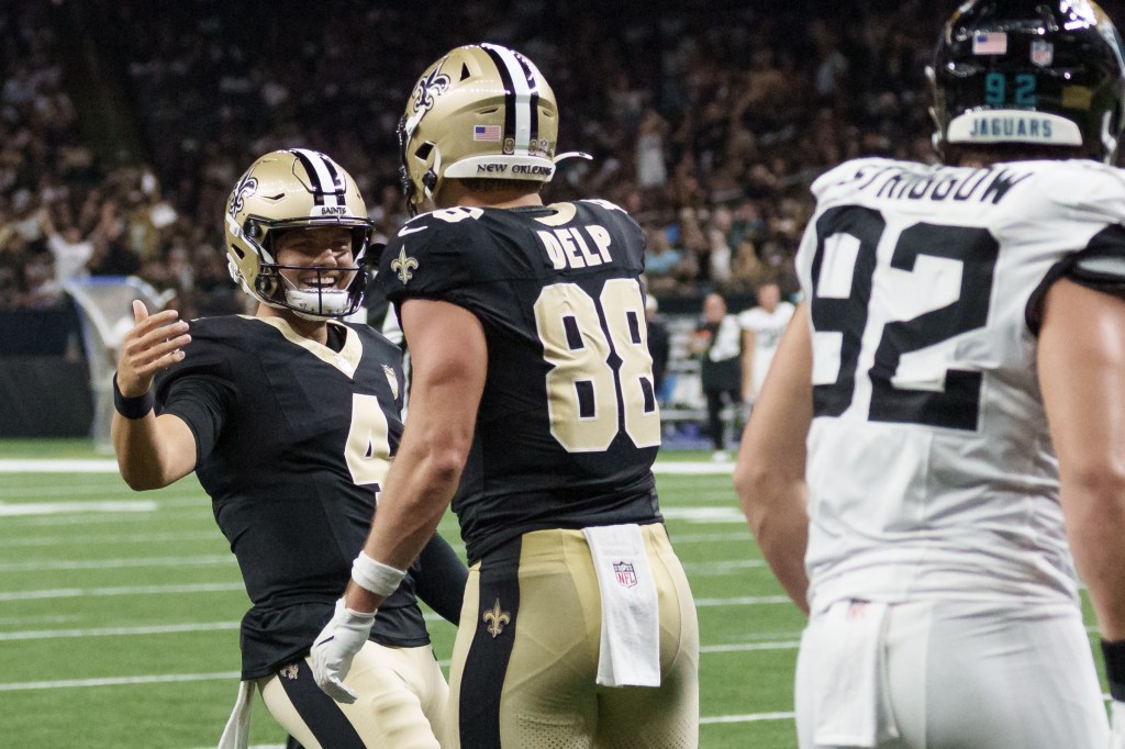 NFL players from the Jacksonville Jaguars and New Orleans Saints on the field.