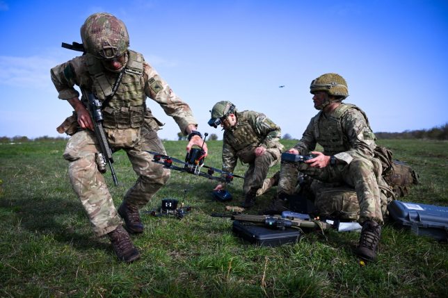 WARMINSTER, ENGLAND - MARCH 30: Soldiers from 16 Air Assault Brigade (16 Air Asslt Bde) set up and fly their military drones after jumping from a Royal Air Force (RAF) A400M transport aircraft onto Salisbury Plain at Copehill Down training facility on March 30, 2026 near Warminster, England. Around 270 soldiers from 16 Air Assault Brigade are carrying out a 