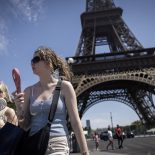 Women use electric fans to cool off during a heatwave in Paris on July 10, 2026. (Photo by Behrouz MEHRI / AFP via Getty Images)