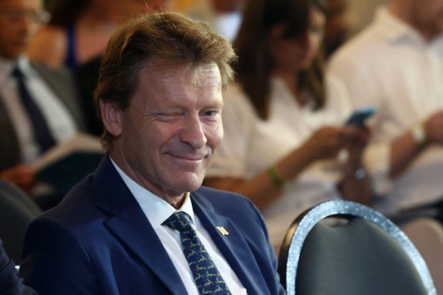 Reform UK deputy Leader Richard Tice winks as Reform UK leader Nigel Farage and the party's head of policy, Zia Yusuf, attend a press conference at a hotel in central London on August 3, 2026. (Photo by Toby Shepheard / AFP via Getty Images)